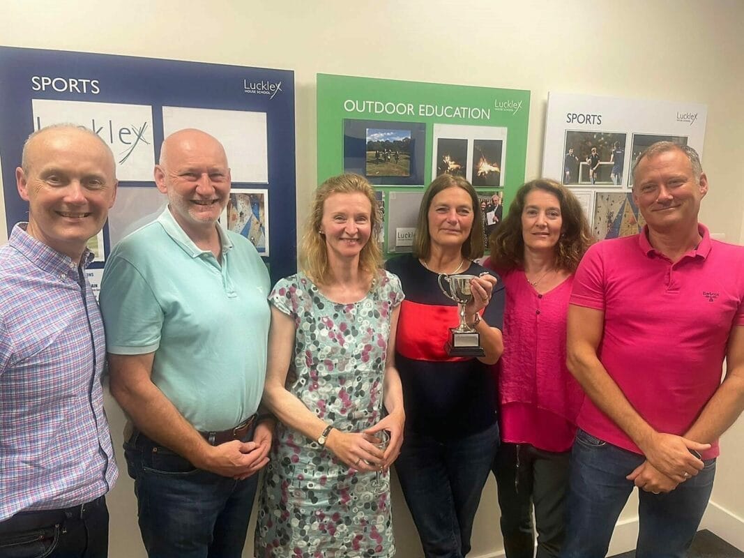 teachers holding a trophy