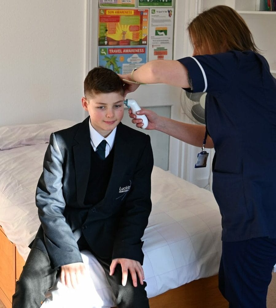 boy having his ear examined by the nurse