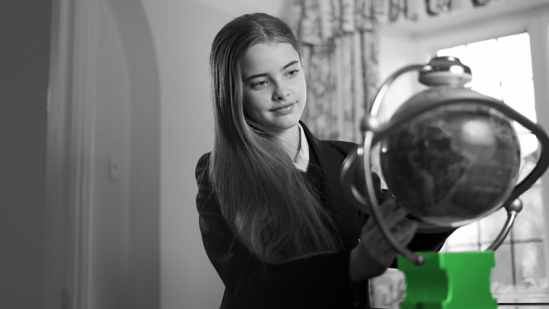 Student looking at a globe