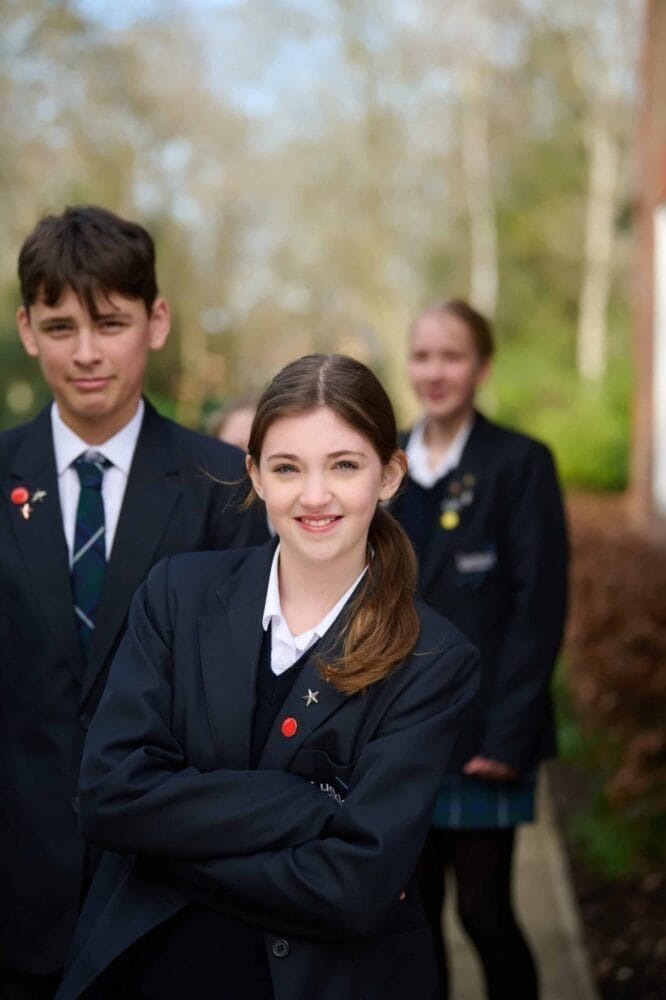 students folding arms or smiling